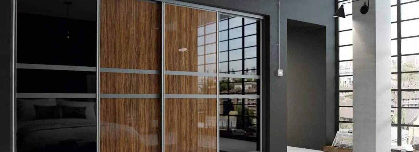Sliding wardrobe visualisation with walnut gloss and black glass panels in an aluminium frame
