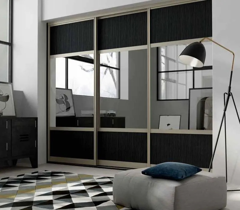 Sliding wardrobe visualisation with black textured panels, central mirror sections and a champagne frame